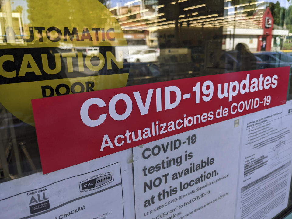 A sign is posted "COVID-19 testing in NOT available at this location," on the doors of a CVS pharmacy in Los Angeles Wednesday, Feb. 3, 2021. California's rollout has been bumpy and chaotic, marked by differing county rules and too little vaccine. The Biden administration has pledged to ramp up delivery, and on Tuesday, Feb. 2, CVS pharmacies announced it would start inoculating people in some California stores next week.(AP Photo/Damian Dovarganes)