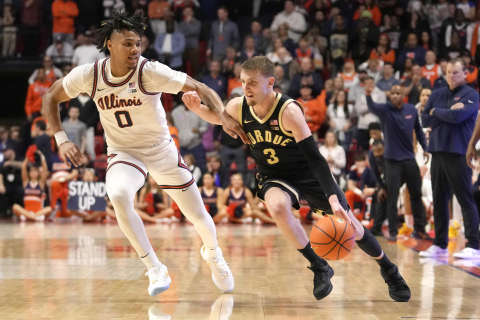 Purdue's Braden Smith (3) drives to the basket as Illinois' Terrence Shannon Jr. defends during the second half of an NCAA college basketball game Tuesday, March 5, 2024, in Champaign, Ill. Purdue won 77-71. (AP Photo/Charles Rex Arbogast)