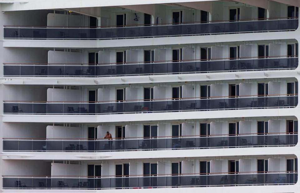 Crew members aboard MSC Divina can be seen passing the time on their balconies as the ship is docked at PortMiami on Friday, May 15, 2020, in Miami, Florida.