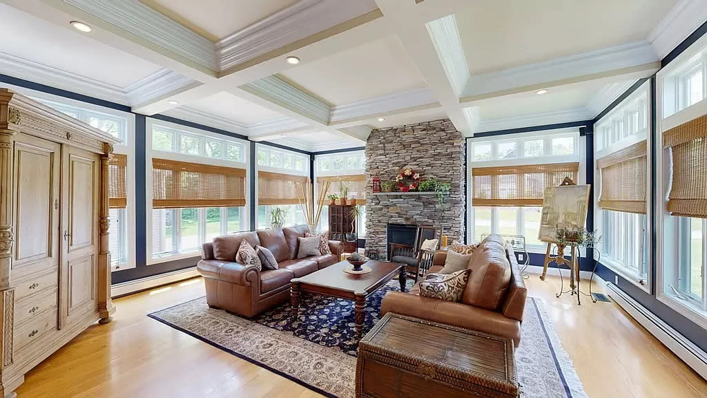 This home at 25 Sarah Drive in Bridgewater that sold for $869,900 on Aug. 29, 2023, has coffered ceilings, floor-to-ceiling glass walls and a stone gas fireplace.