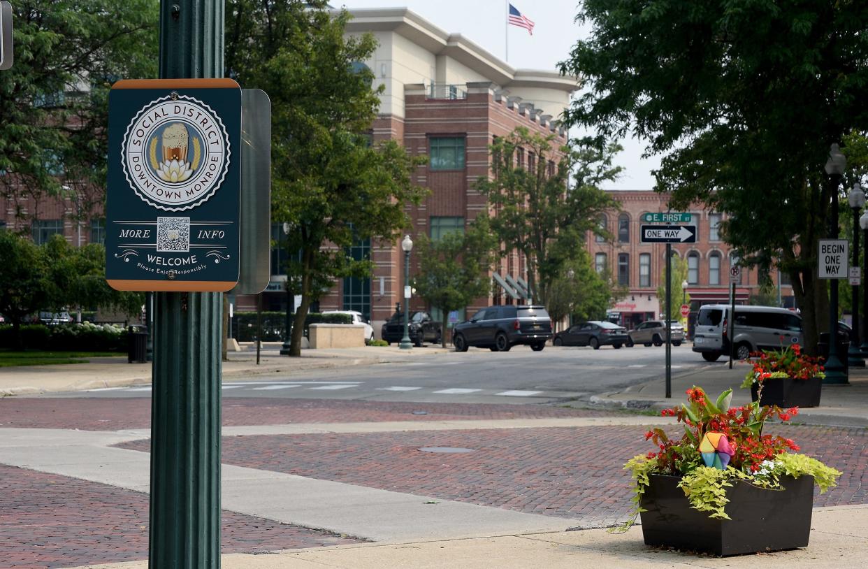 A sign posted for the social district boundary in downtown Monroe at the corner of East First Street and Washington Street.