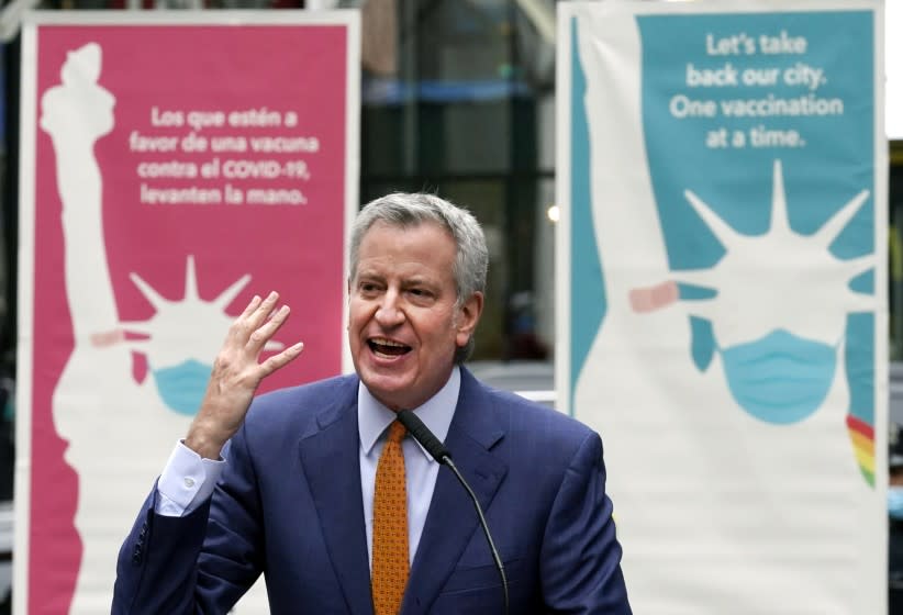 FILE - In this Monday, April 12, 2021 file photo, New York Mayor Bill de Blasio delivers remarks in Times Square after he toured the grand opening of a Broadway COVID-19 vaccination site intended to jump-start the city's entertainment industry, in New York. Blasio expects the city to "fully reopen" by July 1, with the lifting of the city's COVID-19 restrictions. He told MSNBC the city will be ready for stores, offices and theaters to open at full strength. He cited improved COVID-19 vaccination rates and decreasing hospitalization rates. (AP Photo/Richard Drew, File)