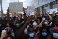 People protest outside the Palace of Justice Tuesday, June 2, 2020 in Paris. French authorities banned the protest over racial injustice and heavy-handed police tactics as global outrage over what happened to George Floyd in the United States kindled frustrations across borders and continents. Family and friends of Adama Traore, a French black man who died shortly after he was arrested by police in 2016, call for a protest which will also pay homage to George Floyd. (AP Photo/Michel Euler)