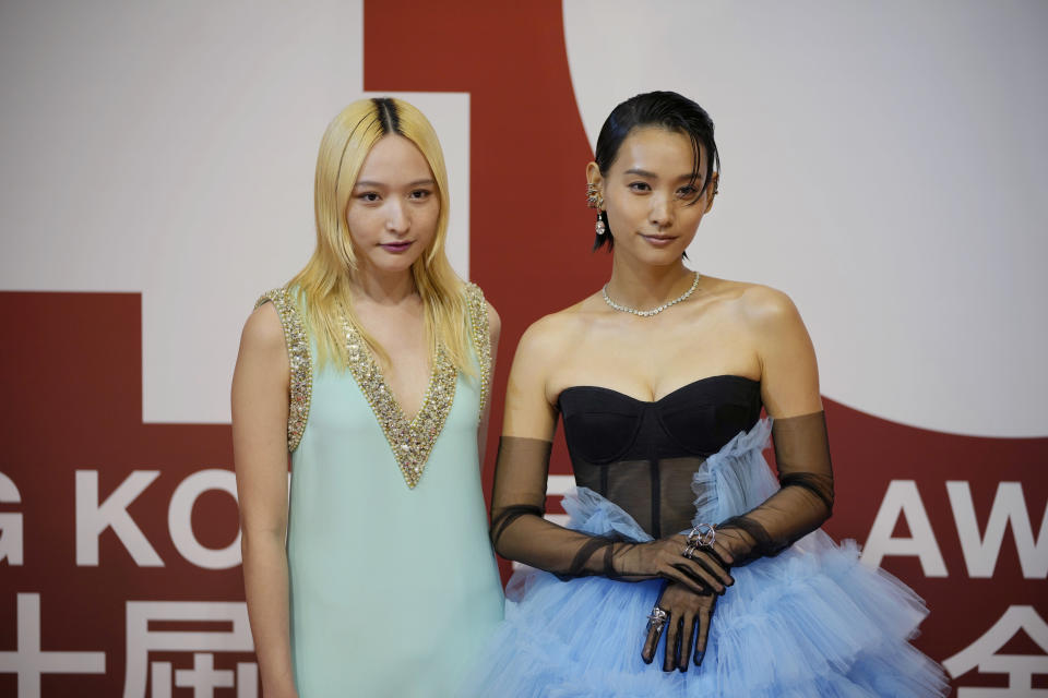 Hong Kong actresses Hedwig Tam, right, and Hanna Chan pose on red carpet at the Hong Kong Film Awards, Sunday, July 17, 2022. (AP Photo/Kin Cheung)