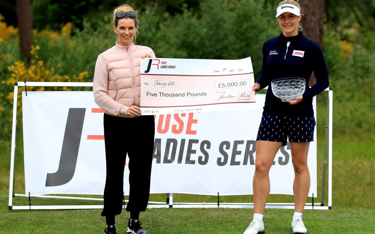 Charley Hull of England receives the winner's cheque from Kate Rose, wife of Justin Rose, after a play-off victory over Liz Young in The Rose Ladies Series at Brockenhurst Manor Golf Club on June 18, 2020  - Andrew Redington/Getty Images