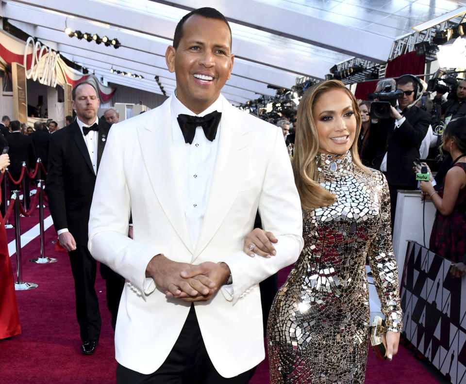 FILE - In this Sunday, Feb. 24, 2019, file photo, Alex Rodriguez, left, and Jennifer Lopez arrive at the Oscars at the Dolby Theatre in Los Angeles. Multiple reports based on anonymous sources say Lopez and Rodriguez called off their two-year engagement. The former New York Yankees shortstop proposed to the actor a couple years ago after the celebrity couple started dating in early 2017. (Photo by Charles Sykes/Invision/AP, File)