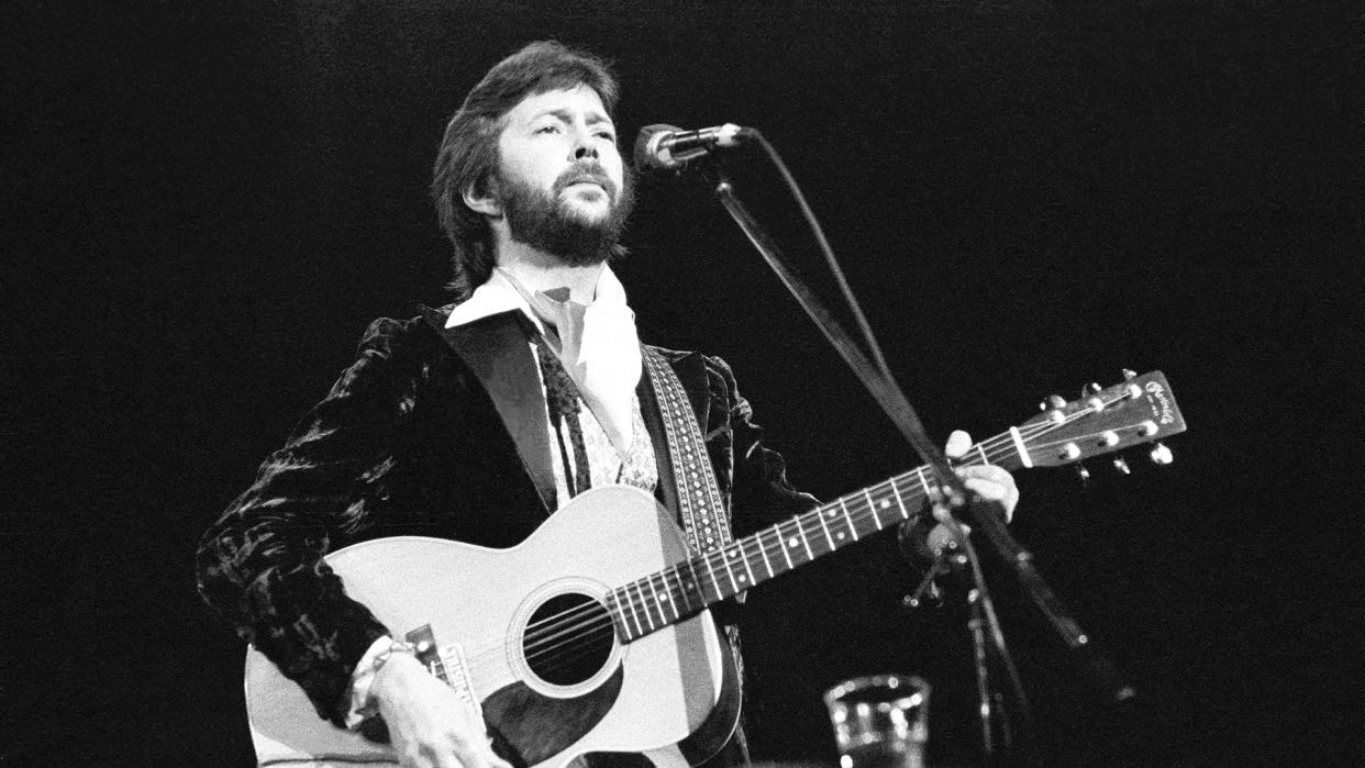  Eric Clapton playing his 1974 Martin 000-28 acoustic guitar onstage in 1977 at the Hammersmith Odeon, London. 