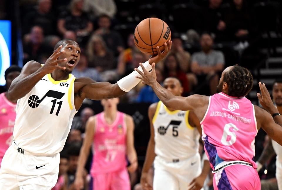 Utah Jazz guard <a class="link " href="https://sports.yahoo.com/nba/players/5636" data-i13n="sec:content-canvas;subsec:anchor_text;elm:context_link" data-ylk="slk:Kris Dunn;sec:content-canvas;subsec:anchor_text;elm:context_link;itc:0">Kris Dunn</a> (11) tries to keep the ball away from Breakers’ Parker Jackson-Cartwright as the Utah Jazz and the New Zealand Breakers play at the Delta Center in Salt Lake City on Monday, Oct. 16, 2023. | Scott G Winterton, Deseret News