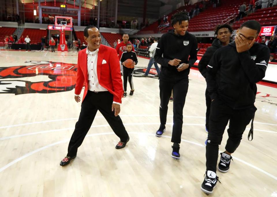 N.C. State head coach Kevin Keatts laughs with signees Josh Hall, center, and Shakeel Moore, right, after a game in Raleigh in 2019. Hall turned pro and never attended N.C. State while Moore played for the Wolfpack last season. Both attended Moravian Prep in Hickory.