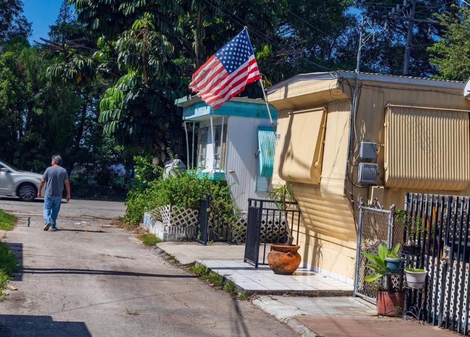 A resident walks along the street at the Gables Trailer Park, which has approximately 90 trailers and is located across from Graceland Memorial Park North on SW 44th Avenue. Residents are worried about being displaced as the city of Coral Gables is moving forward with the annexation process, on Wednesday, October 18, 2023.