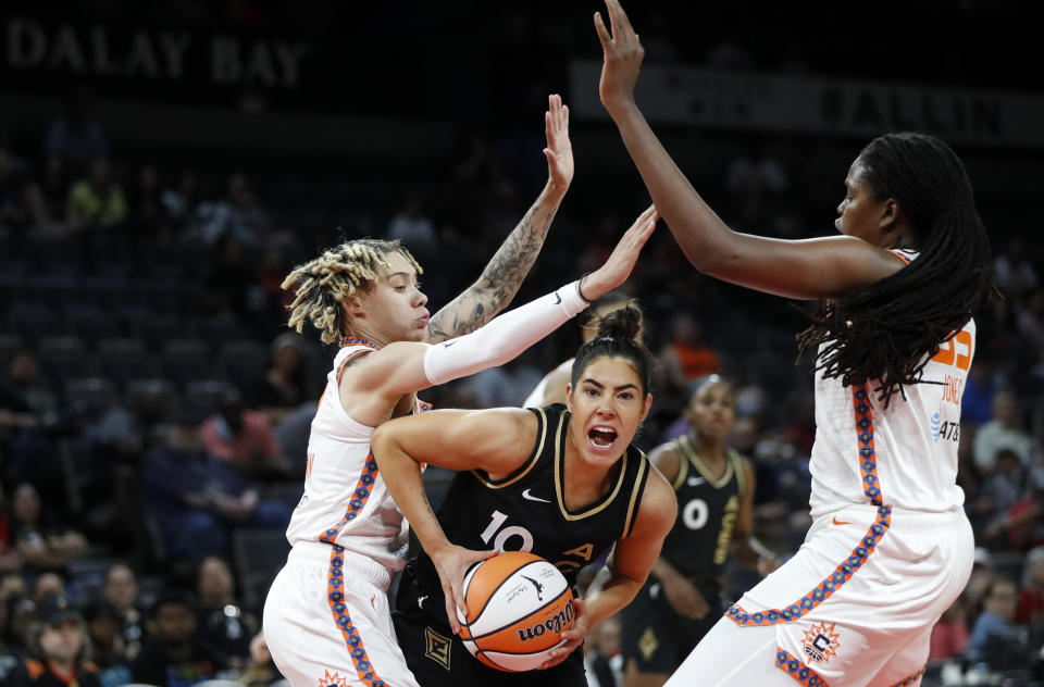 Las Vegas Aces guard Kelsey Plum (10) is guarded by Connecticut Sun guard Courtney Williams, left, and forward Jonquel Jones (35) during a WNBA basketball game in Las Vegas on Thursday, June 2, 2022. (Steve Marcus/Las Vegas Sun via AP)