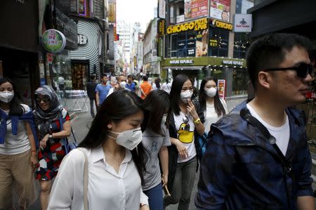 Women wearing masks to prevent contracting Middle East Respiratory Syndrome (MERS) walk at Myeongdong shopping district in central Seoul, South Korea, June 11, 2015. REUTERS/Kim Hong-Ji