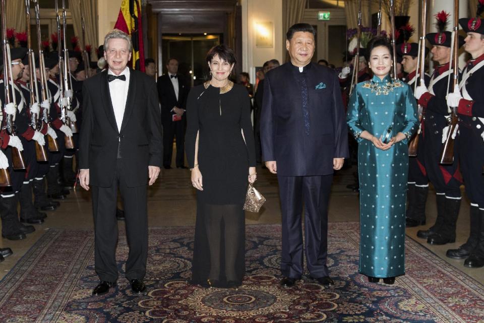 Swiss Federal President Doris Leuthard and her husband Roland Hausin, left, and China's President Xi Jinping, 2nd right, and his wife Peng Liyuan, right, arrive at a gala dinner in Bern, Switzerland, Sunday, Jan. 15, 2017. Xi on Sunday kicked off a four-day visit to Switzerland, the first this century by a Chinese leader. It includes planned stops in Geneva, Lausanne and to the World Economic Forum in Davos. (Peter Klaunzer/Pool Photo via AP)
