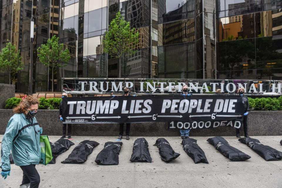 Members of the protest group Rise and Resist place mock body bags in front of the Trump International Hotel. Source: Getty