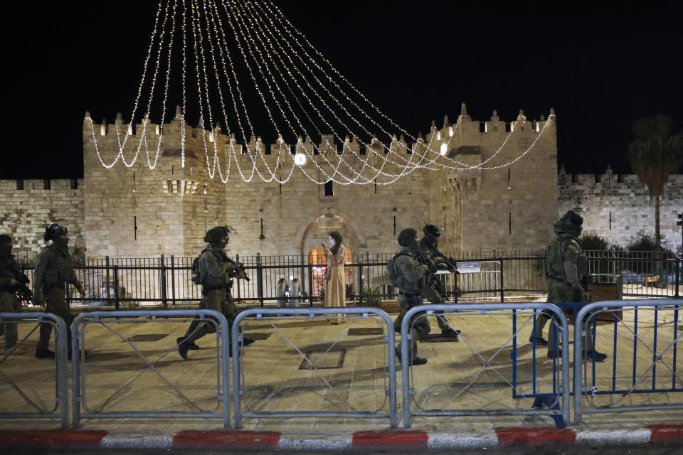 Israeli border police officers deploy during clashes with Palestinian protesters next to Damascus Gate in Jerusalem's old city, Friday, May 7. 2021. Palestinians protested over Israel's threatened eviction of dozens of Palestinians in the Sheikh Jarrah neighborhood in east Jerusalem, who have been embroiled in a long legal battle with Israeli settlers trying to acquire property in the neighborhood. (AP Photo/Mahmoud Illean)