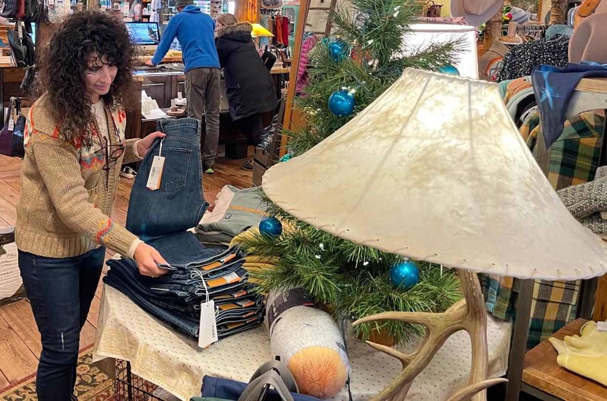 DeAnn Echols, owner of the Great Outdoor Store in downtown Sioux Falls, prepares for the holiday season by sorting merchandise on Nov. 18. DeAnn and her husband, James, have focused more on in-person customer experience than online sales.