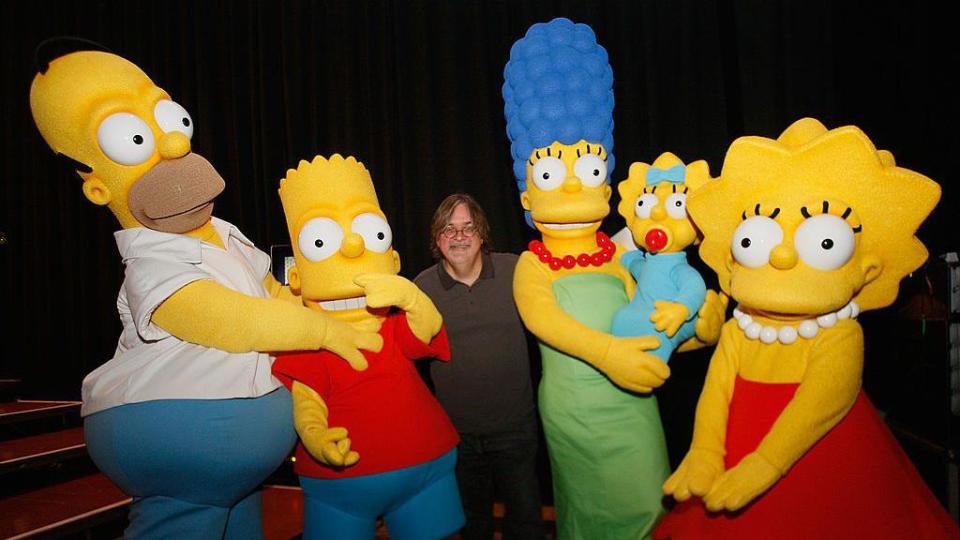 Creator Matt Groening poses with Simpson characters at 