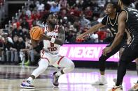Texas Tech guard Joe Toussaint, left, brings the ball upcourt against Central Florida guards Shemarri Allen, second from right, and Darius Johnson, right, during the first half of an NCAA college basketball game, Saturday, Feb. 10, 2024, in Lubbock, Texas. (AP Photo/Justin Rex)