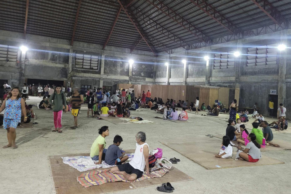 In this photo provided by the Local Government Unit of Hinatuan, villagers stay at a temporary evacuation center after an earthquake at Hinatuan town, Surigao del Sur province, southern Philippines, late Saturday, Dec. 2, 2023. A powerful earthquake with a preliminary magnitude of 7.6 struck Saturday off the southern Philippine coast, prompting many villagers to flee their homes in panic around midnight after Philippine authorities issued a tsunami warning. (LGU Hinatuan via AP)