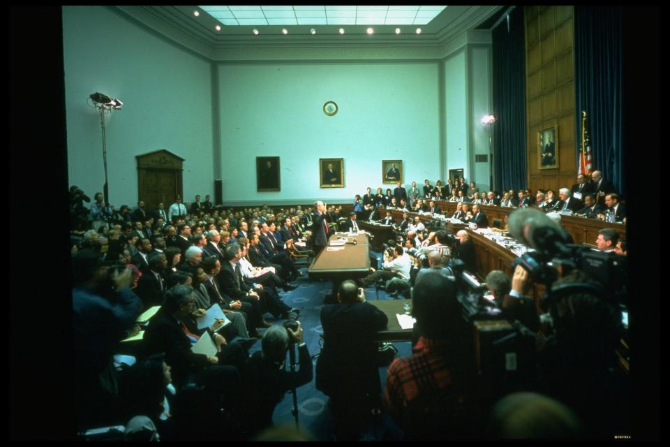 Independent counsel Ken Starr (C) raising hand, swearing-in before House Judiciary Committee, testifying in impeachment inquiry against Pres. Clinton in Capitol Hill committee room panorama.