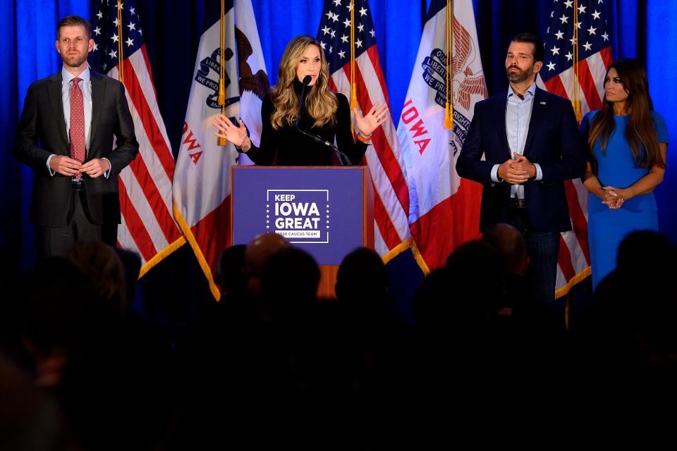 Lara Trump, with her husband, Eric Trump, speaks with Donald Trump Jr. and his girlfriend Kimberly Guilfoyle at a "Keep Iowa Great" news conference in Des Moines, Iowa.