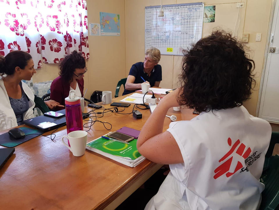 In this Oct. 8, 2018, photo provided by Medecins Sans Frontieres Australia, Australia executive director Paul McPhun, third from left, talks with MSF Nauru mental health team members in Nauru. Humanitarian medical professionals expelled from Nauru said on Thursday, Oct. 11, 2018, asylum seekers that Australia had banished to the tiny Pacific atoll were suicidal and their children have lost hope. The Nauru government forced Doctors Without Borders out of the country last week, abruptly ending their free medical care for asylum seekers refugees and local Nauruans. (Medecins Sans Frontieres Australia via AP)