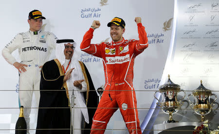 Formula One - F1 - Bahrain Grand Prix - Sakhir, Bahrain - 16/04/17 - Ferrari Formula One driver Sebastian Vettel of Germany (R) celebrates after winning Bahrain Grand Prix. REUTERS/Hamad I Mohammed