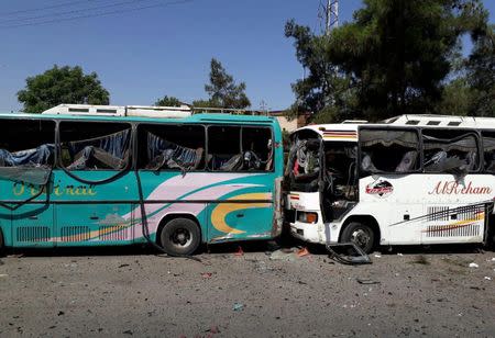 Damaged buses are pictured at one of the blast sites in Damascus in this handout picture posted on SANA on July 2, 2017, Syria. SANA/Handout via REUTERS