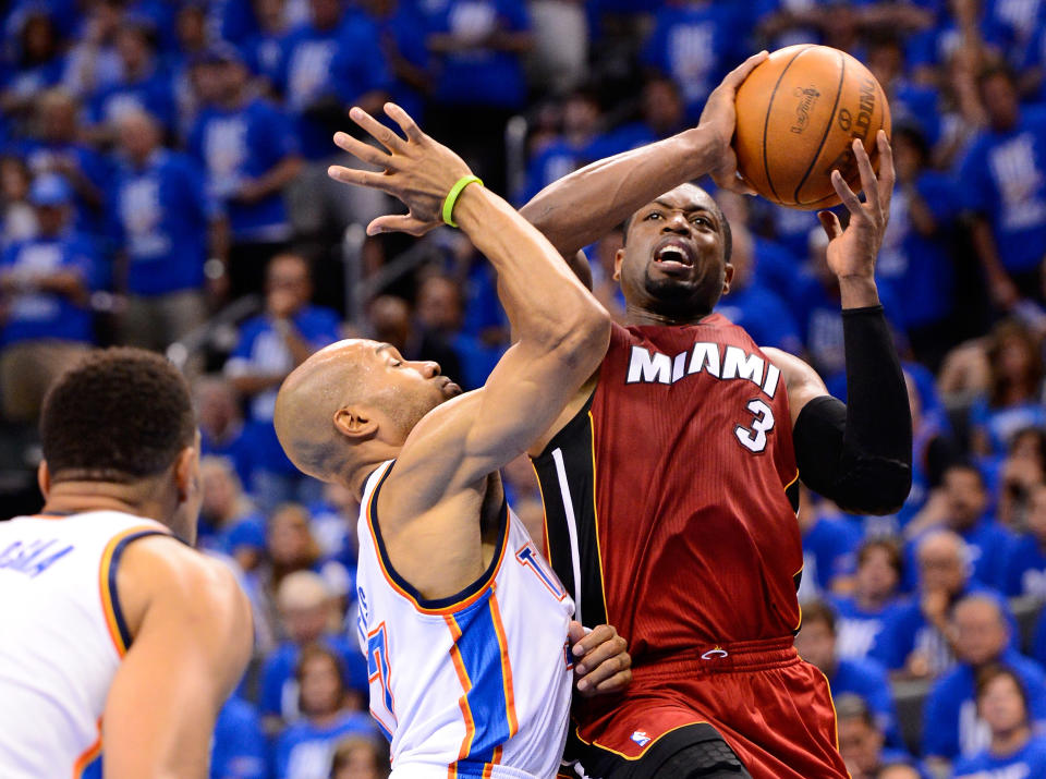 Dwyane Wade #3 of the Miami Heat goes up for a shot over Derek Fisher #37 of the Oklahoma City Thunder in the second half in Game One of the 2012 NBA Finals at Chesapeake Energy Arena on June 12, 2012 in Oklahoma City, Oklahoma. (Photo by Ronald Martinez/Getty Images)