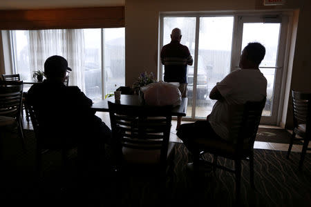 People watch Hurricane Michael from a hotel window in Panama City Beach, Florida, U.S., October 10, 2018. REUTERS/Jonathan Bachman