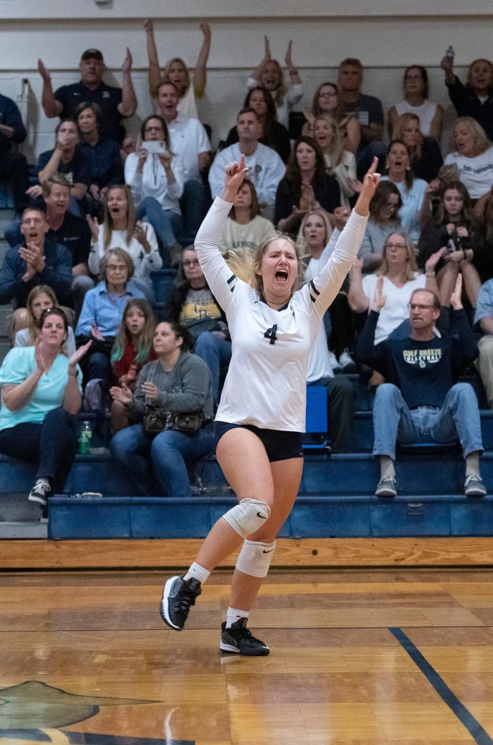 Gulf Breeze High School's Riley Bloomberg (No. 4)  celebrates the Dolphins' victory over Navarre High School during Wednesday's Region 1-6A quarterfinals match. The dolphins sweep the raiders in three straight 25-20, 25-18, 25-16.
