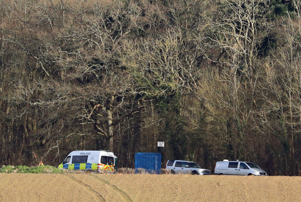 Police vehicles at the scene where human remains, that have been identified as that of 33-year-old Sarah Everard, were found hidden in woodland in Ashford, Kent. The Met Police announced on Wednesday that the diplomatic protection officer held over the disappearance of Sarah Everard has been arrested on suspicion of murder. Picture date: Friday March 12, 2021.