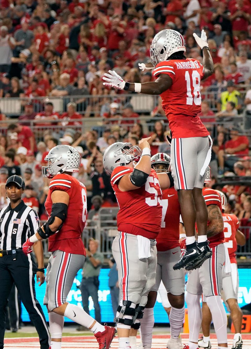 Ohio State center Luke Wypler hoists receiver Marvin Harrison Jr. into the air after Harrison Jr. scored a touchdown last week against Toledo.