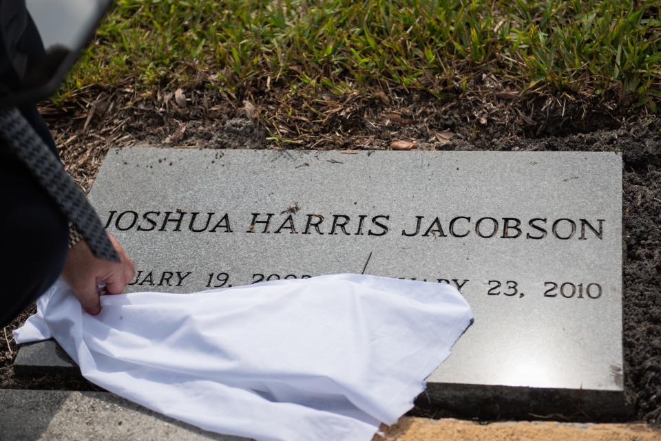 Rabbi Daniel Krimsky of Temple B'nai Jacob of Wellington unveils the headstone of Joshua Jacobson at the Star of David Cemetery of the Palm Beaches on May 31, 2023, in Palm Beach Gardens, Fla. Recently, an anonymous donor provided funds to purchase headstones for the graves of Franki Jacobson and her twin boys Eric and Joshua, who were killed 13 years ago by Neal Jacobson.