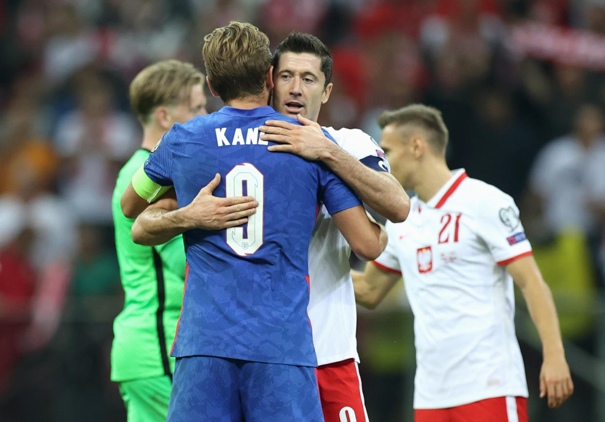 Harry Kane and Robert Lewandowski embrace.