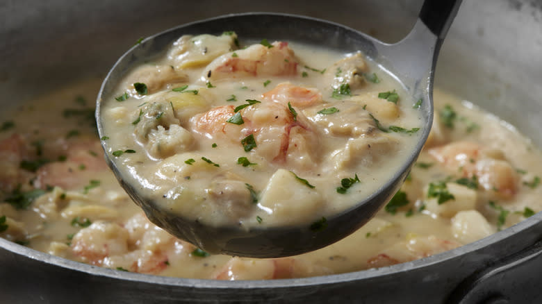 Bowl of seafood chowder being ladled