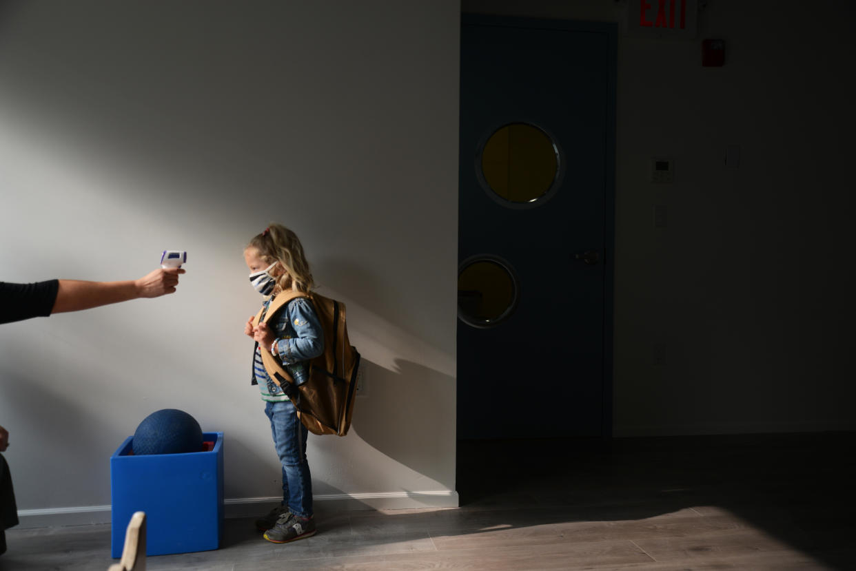 Students return for their first day of in-class schooling following the pandemic at New York City's Preschool of the Arts, having their temperatures checked before proceeding into the school, Tuesday, 15 September 2020.   (Photo by B.A. Van Sise/NurPhoto via Getty Images)