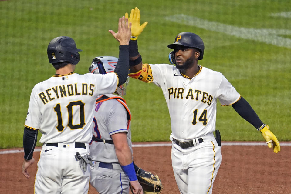 Pittsburgh Pirates' Rodolfo Castro (14) celebrates with Bryan Reynolds (10) after hitting a two-run home run off New York Mets starting pitcher Taijuan Walker during the third inning of a baseball game in Pittsburgh, Tuesday, Sept. 6, 2022. (AP Photo/Gene J. Puskar)