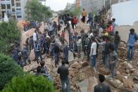 Nepalese rescue members remove the body from Dharahara Tower in Kathmandu, on April 25, 2015