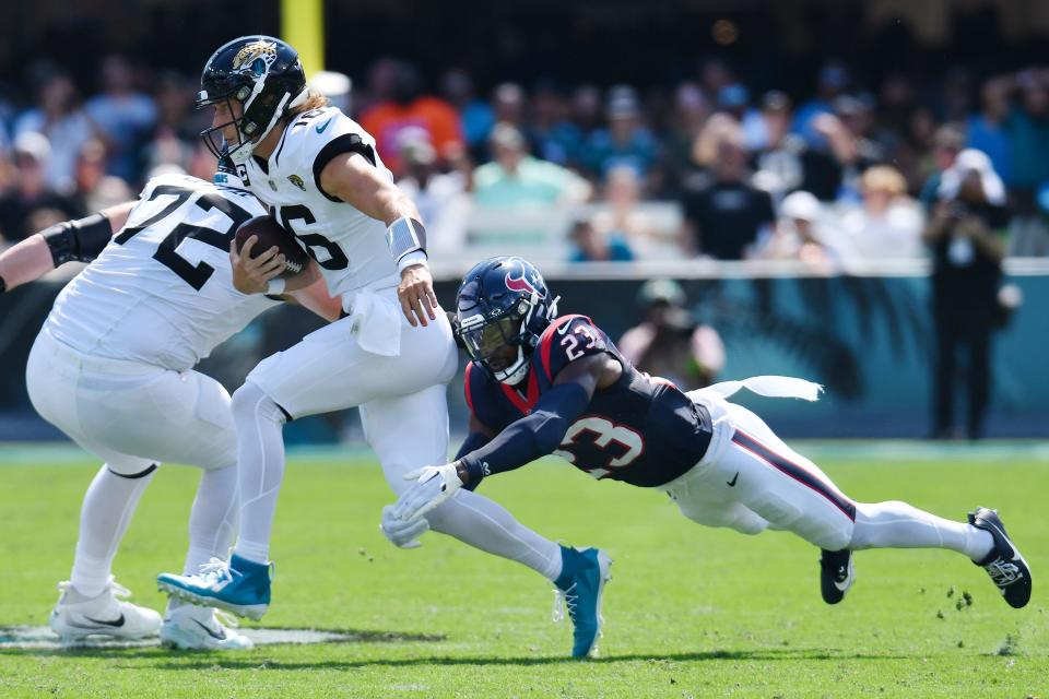 Jaguars quarterback Trevor Lawrence (16) tries to escape from Texans safety Eric Murray (23) in the first quarter of the AFC South matchup in September.