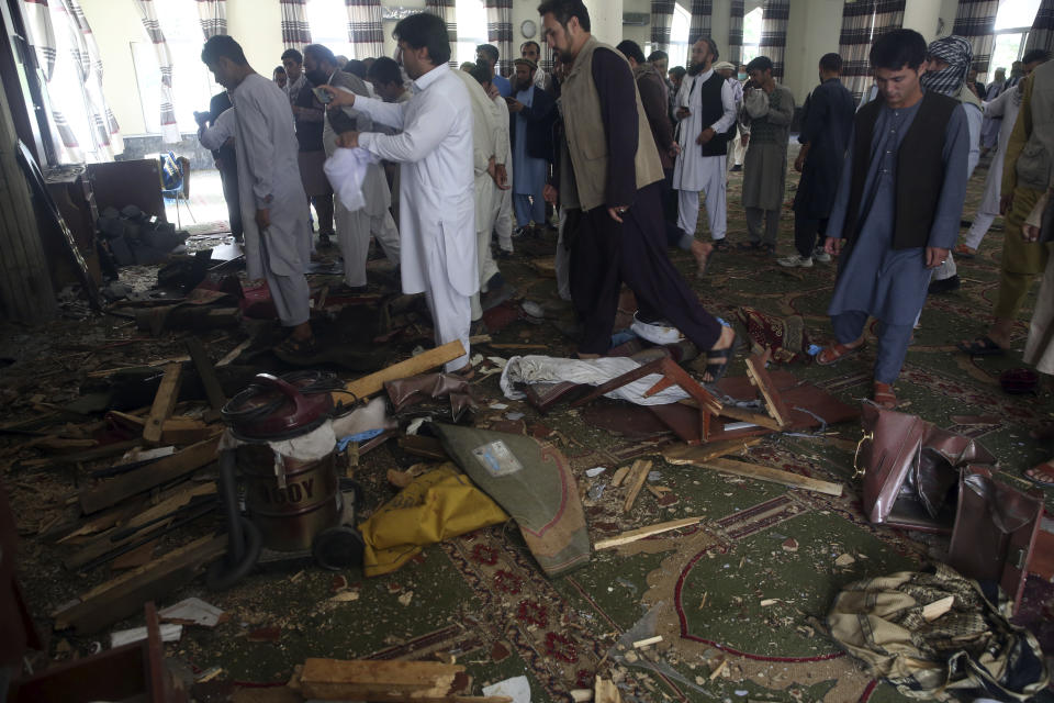 Afghans inspect the inside of a mosque following a bombing, in Kabul, Afghanistan, Friday, June 12, 2020. (AP Photo/Rahmat Gul)