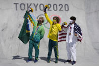 From left, silver medal winner Pedro Barros of Brazil, gold medal winner Keegan Palmer of Australia and bronze medal winner Cory Juneau of the United States pose for photos after the the men's park skateboarding finals at the 2020 Summer Olympics, Thursday, Aug. 5, 2021, in Tokyo, Japan. (AP Photo/Ben Curtis)