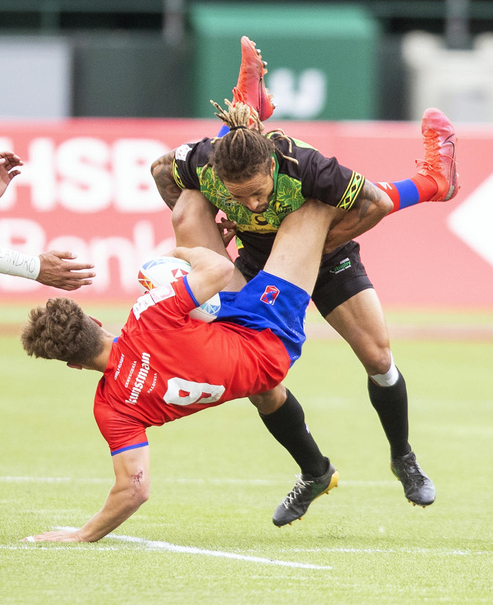 Chile's Sebastian Berti, left, is tackled by Jamaica's Mark Phillips during an HSBC Canada Sevens semifinal rugby match in Edmonton, Alberta, Sunday, Sept. 26, 2021. (Jason Franson/The Canadian Press via AP)