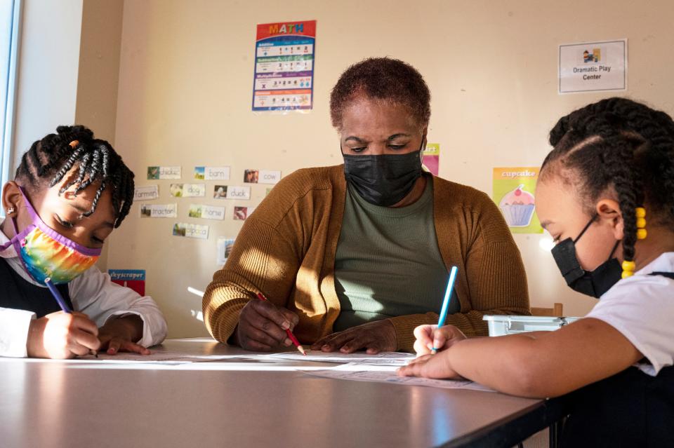 Priscilla Rowell, an early childhood educator, is joined by students Chanel Wright and Logann Holman for a photo shoot at Excel Christian Academy in Burlington, NC, Jan. 12, 2022.