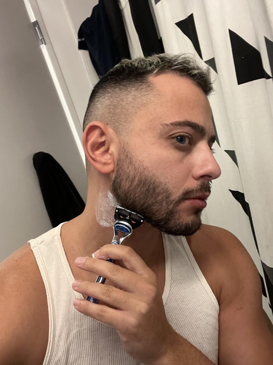 Spy reviewer, joey skladany, using one of the shave butters tested