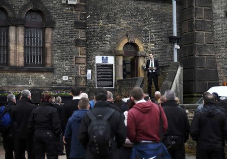 A man speaks to prison guards as they stand outside Wandsworth Reform Prison during an unofficial strike to protest against staffing levels and health and safety issues, in London, Britain, November 15, 2016. REUTERS/Dylan Martinez