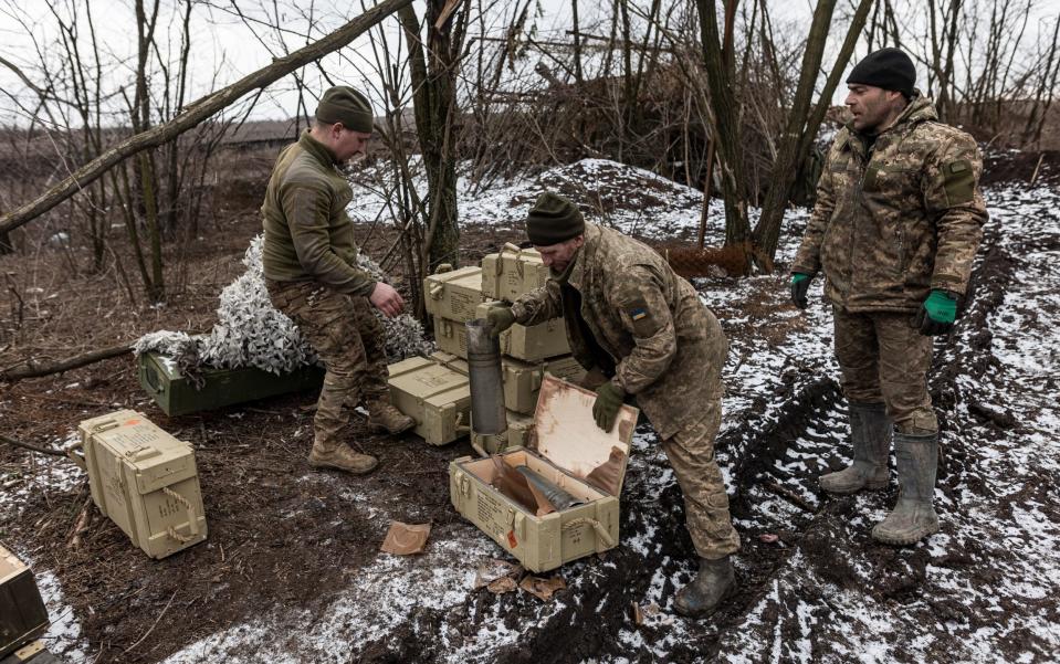 Ukrainian soldiers order ammunition boxes at their fighting position near Bakhmut, Donetsk Oblast, Ukraine, on Tuesday