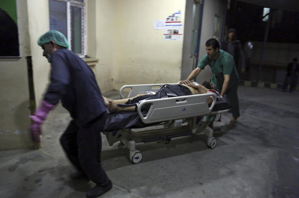 A man injured in a suicide bombing is brought into a hospital in Kabul, Afghanistan, Nov. 20, 2018. Afghan officials said the suicide bomber targeted a gathering of Muslim religious scholars in Kabul, killing tens of people. A Public Health Ministry spokesman said another 60 people were wounded in the attack, which took place as Muslims around the world marked the birthday of the Prophet Mohammad. (AP Photo/Rahmat Gul)