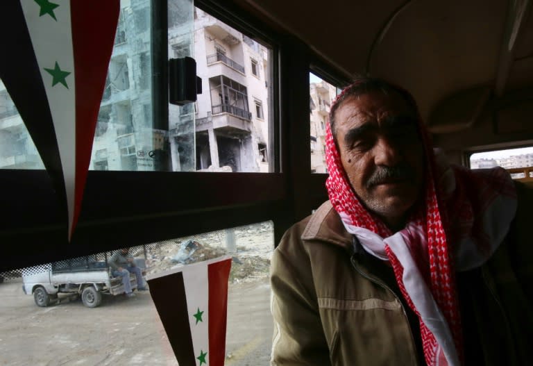 A Syrian man makes a bus journey across Aleppo on December 3, 2016