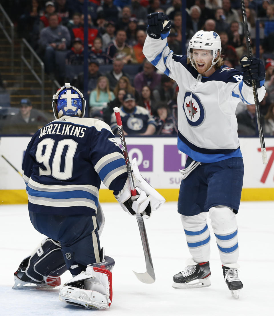 Winnipeg Jets' Kyle Connor, right, celebrates his goal against Columbus Blue Jackets' Elvis Merzlikins, of Latvia, during the first period of an NHL hockey game Wednesday, Jan. 22, 2020, in Columbus, Ohio. (AP Photo/Jay LaPrete)